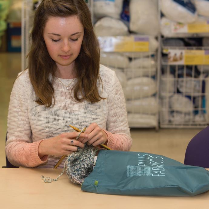 woman sewing and yarn is coming out of her Chicobag versitle reusable ditty bag